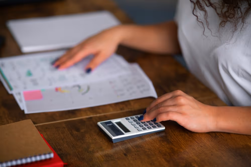 Calculatrice et documents annotés illustrant la simulation du taux marginal d’imposition (TMI).